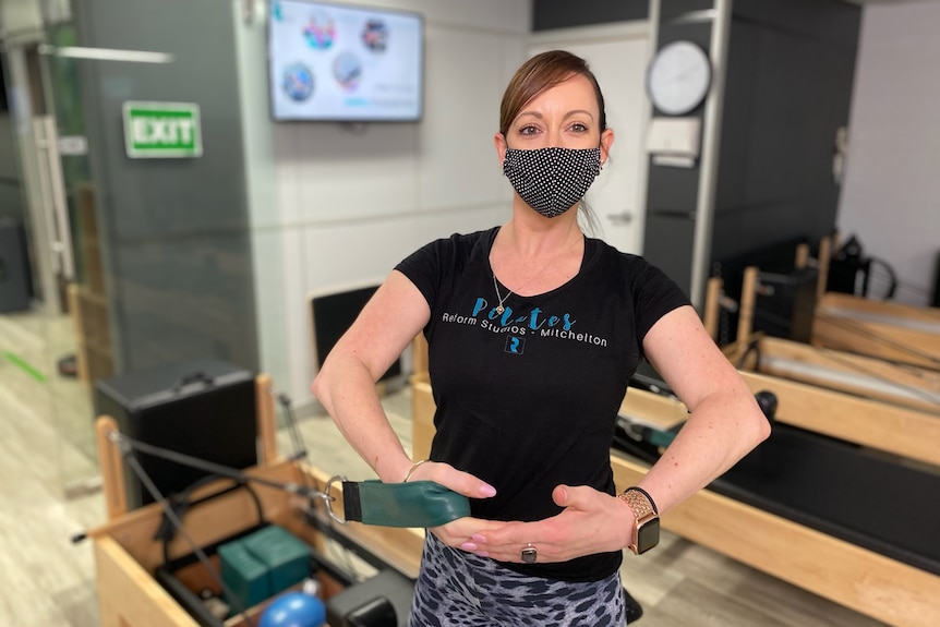 Pilates studio manager Leigh Pugsley wearing a mask while using equipment at the studio.