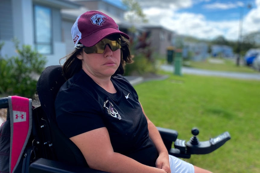 a woman wearing sun glasses outside in her wheelchair