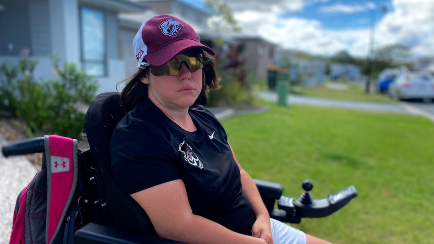 a woman wearing sun glasses outside in her wheelchair