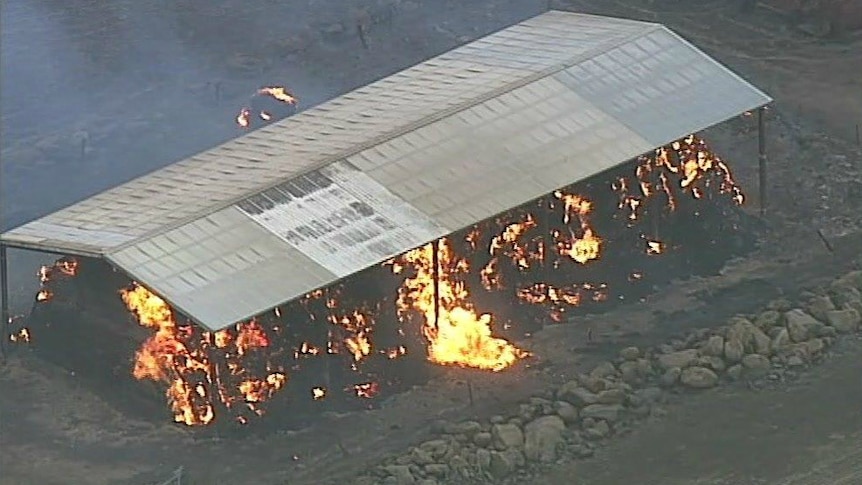 A burning structure is shown from the air.