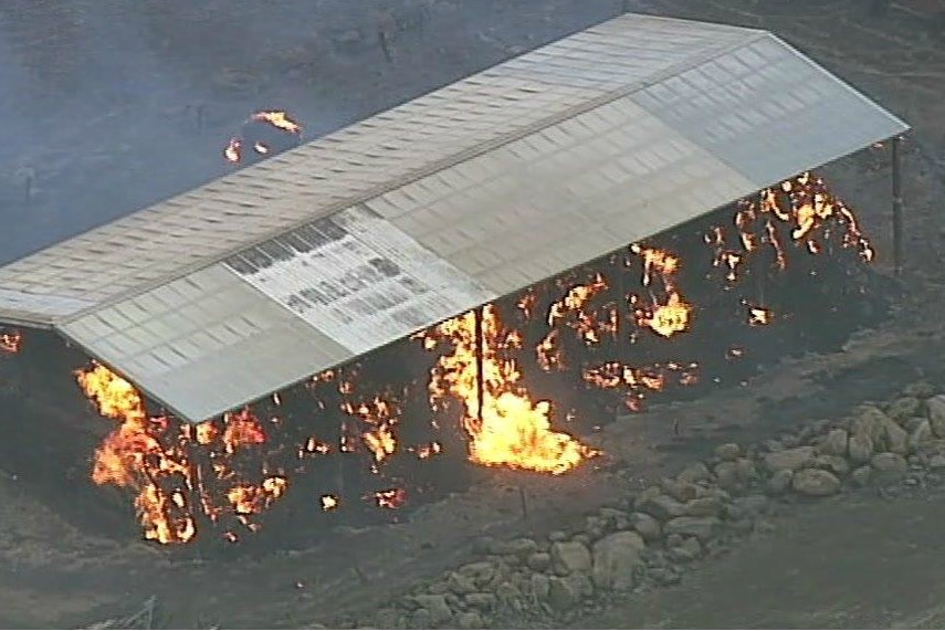 A burning structure is shown from the air.