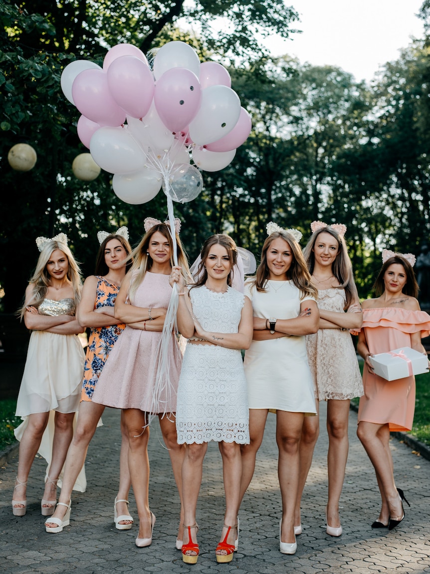 Women holding helium balloons