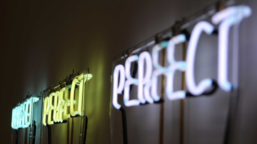 'Perfect Perfect Perfect' neon sign for a story on the problem with striving for perfection