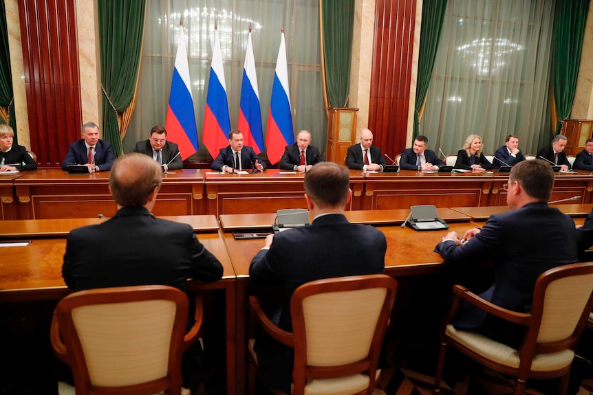 Russian President Vladimir Putin, center, and Russian Prime Minister Dmitry Medvedev, center left, attend a cabinet meeting.