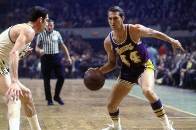 LA Lakers star Jerry West dribbles a basketball in an NBA game against the Boston Celtics.