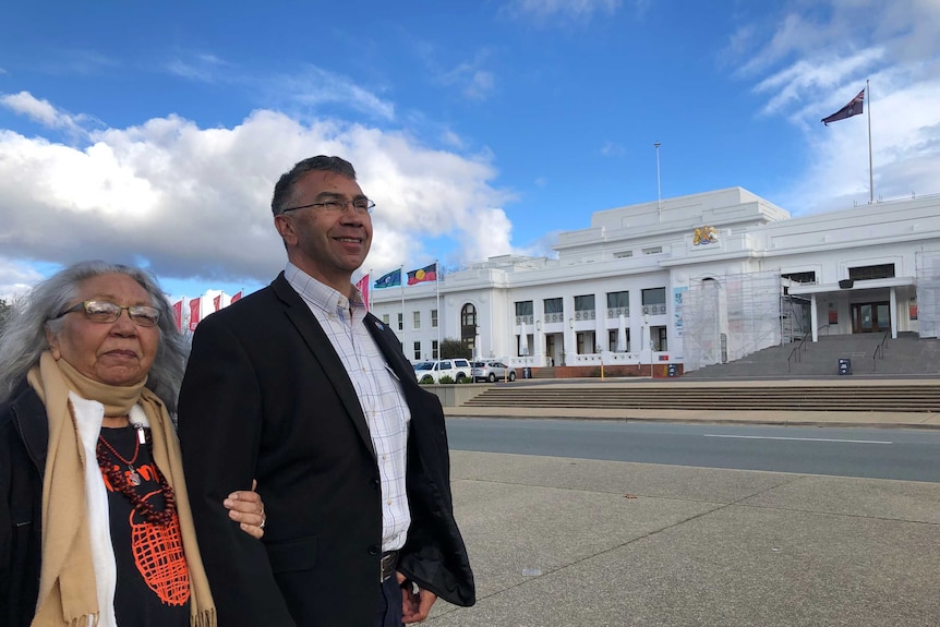 A mother and a son stand outside Old Parliament House.