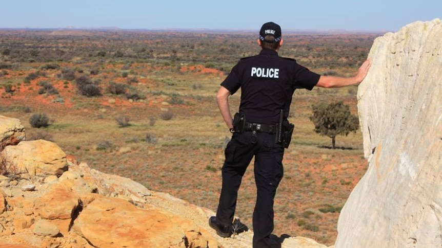 NT Police officer at Chambers Pillar, NT