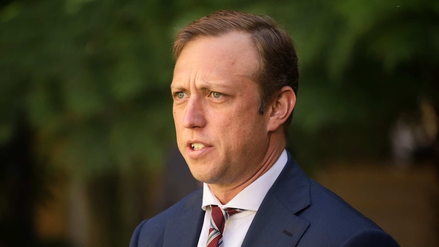Headshot of Queensland Health Minister Steven Miles at a media conference.