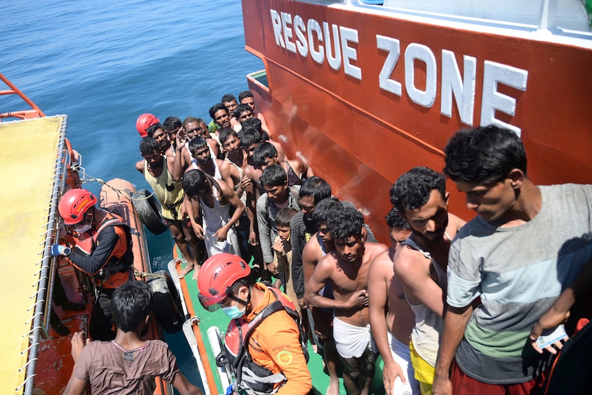 Rohingya refugees board a National Search and Rescue Agency ship