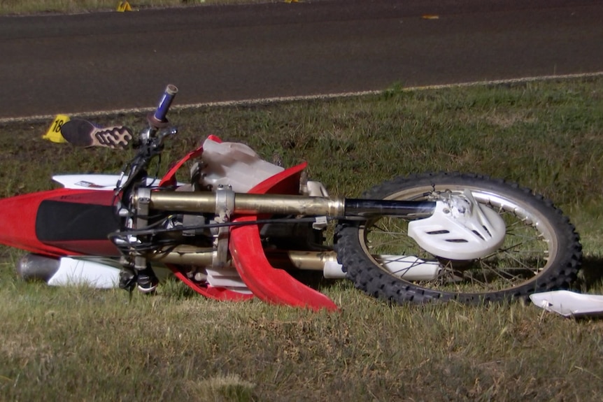 A motorcycle lying on its side.