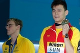 Australian swimmer Mack Horton (left) looks elsewhere while Sun Yang and Gabriele Detti hold up their world championship medals.