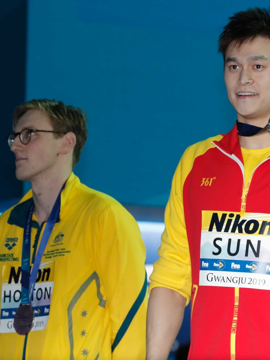 Australian swimmer Mack Horton (left) looks elsewhere while Sun Yang and Gabriele Detti hold up their world championship medals.