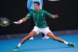 A tennis player skids to the side to get a forehand return away in the Australian Open final.