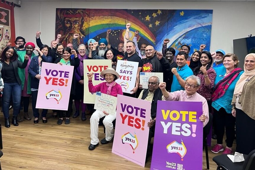 A group of Yes voters hold up signs. 