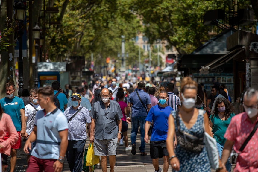 People walk along the Ramblas of Barcelona, Spain.