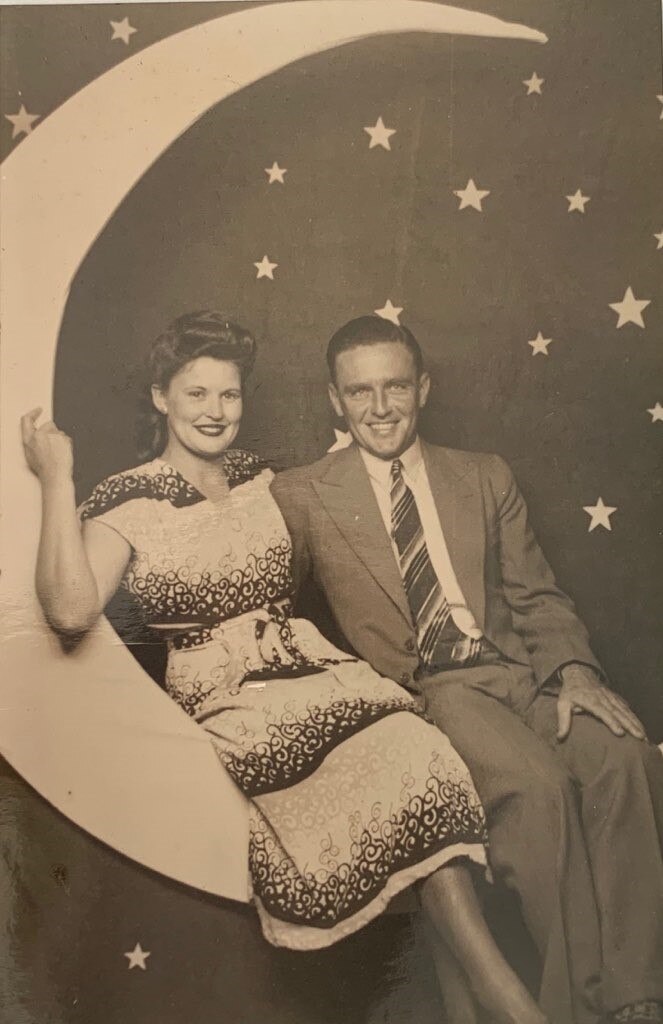 a man and woman smile at the photos