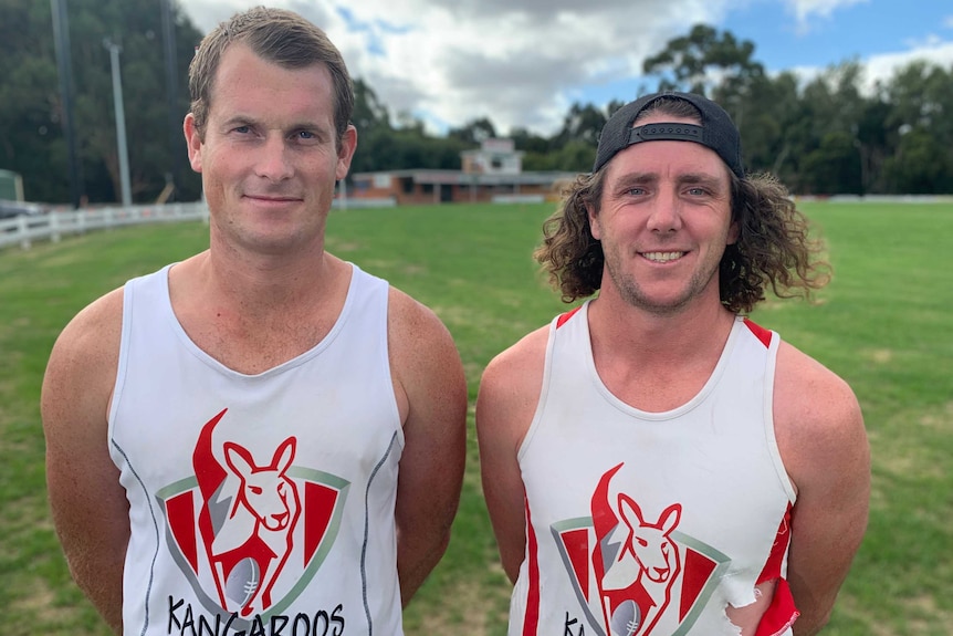 Travis Manne (left) and Brent Cooper standing at the Fish Creek footy ground.