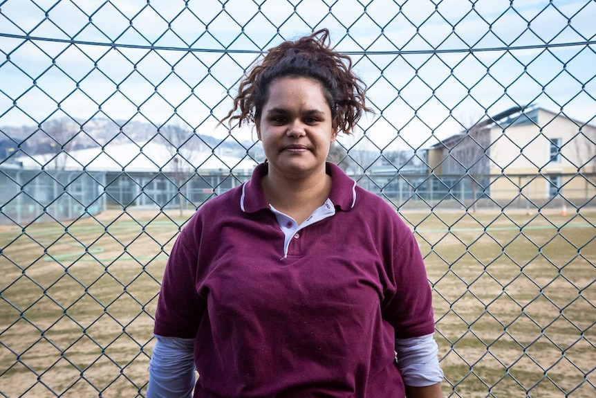 Trudy Murray is standing in the yard the prison where she is detained.