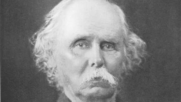 a black and white portrait of Alfred Marshall wearing a jacket