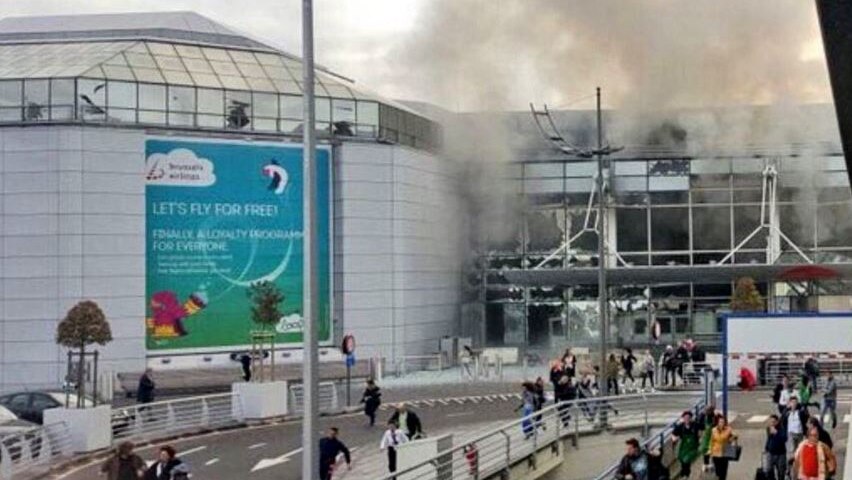 Glass windows blown out and smoke billowing from Brussels airport