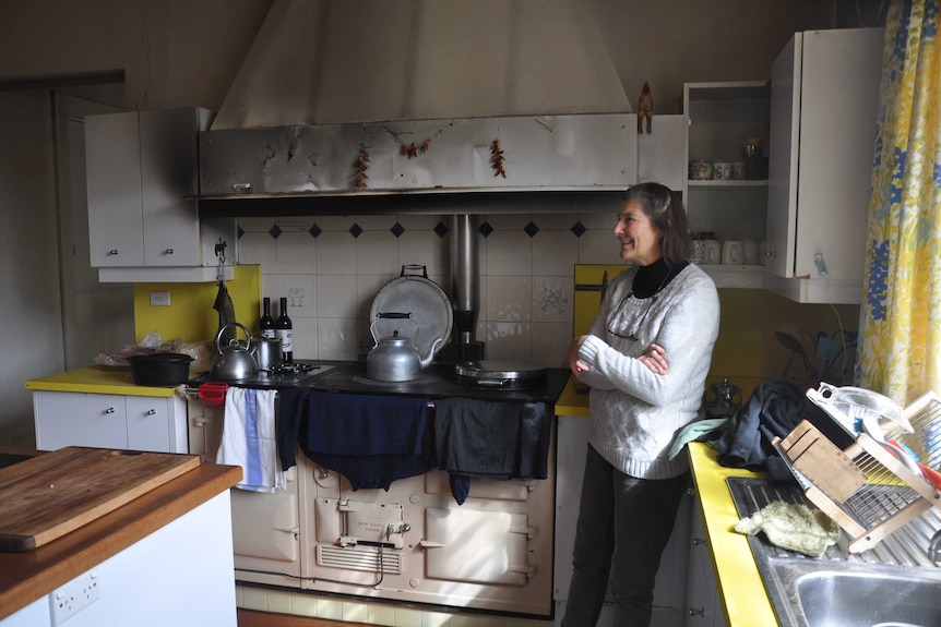 Annabel Walsh stands by the fire in her kitchen at Moorna Station.