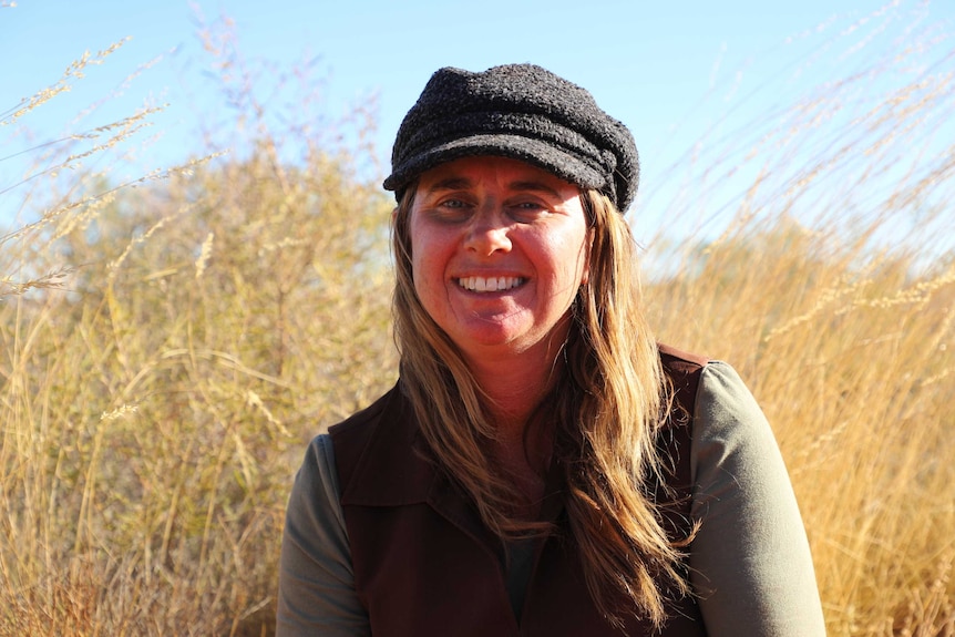 Woman smiling in front of bushland