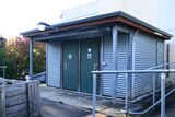 A corrugated iron building with two doors.