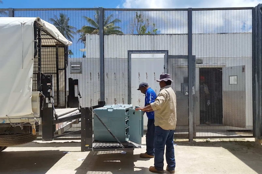 Staff on Manus Island unload catering supplies.