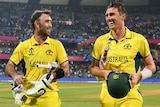 Glenn Maxwell and Pat Cummins walk off the field together after Australia's win over Afghanistan at the Cricket World Cup.