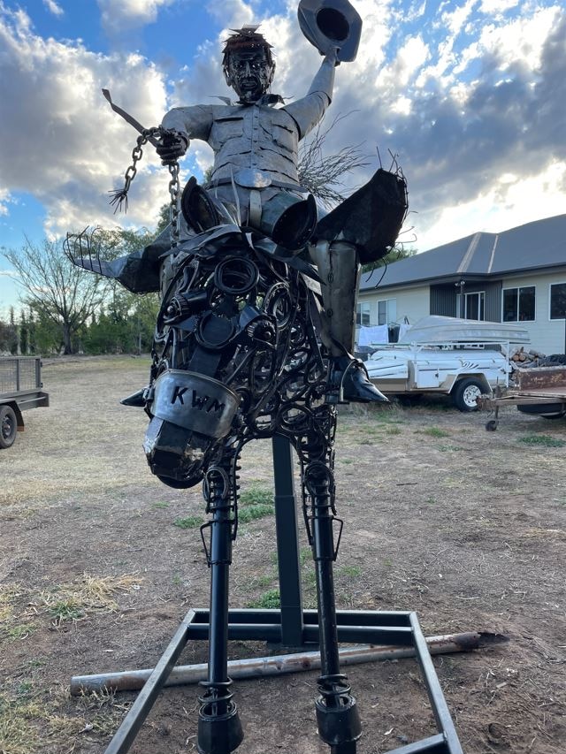 Image of a sculpture of a man riding a horse.