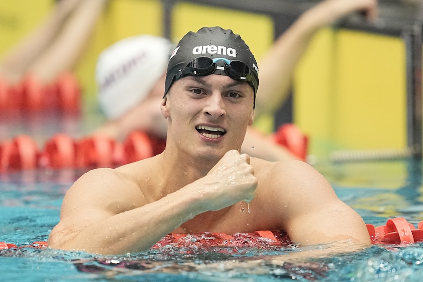 German swimmer Luca Nik Armbruster pumps his fist in the pool after a race