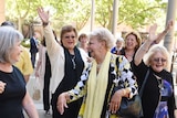 Roseanne Beckett leaves the Supreme Court with her supporters looking jubilant.