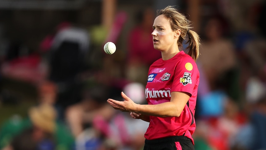 Ellyse Perry tosses the ball in the air as she prepares to bowl against the Adelaide Strikers