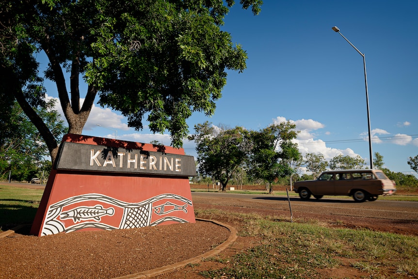 A car drives past the Katherine sign on the outskirts of the township. 