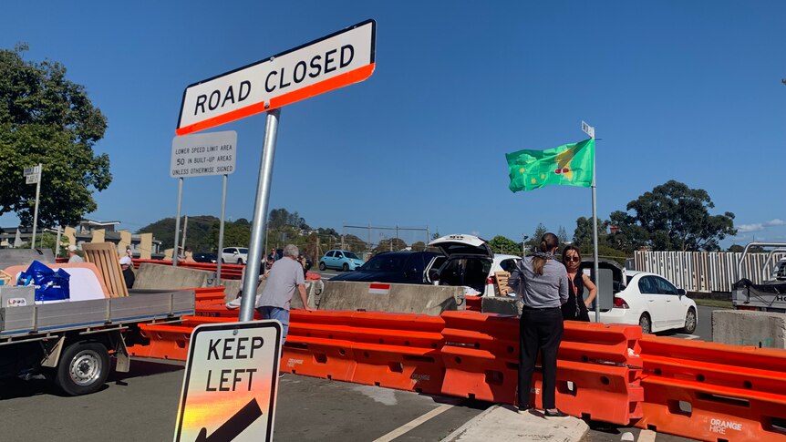 Road closed sign with green kangaroo flag