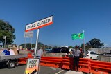 Road closed sign with green kangaroo flag