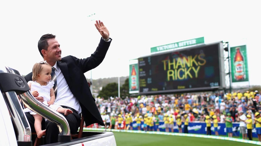 Farewelling a legend... Ricky Ponting waves to the crowd while holding his daughter Matisse.