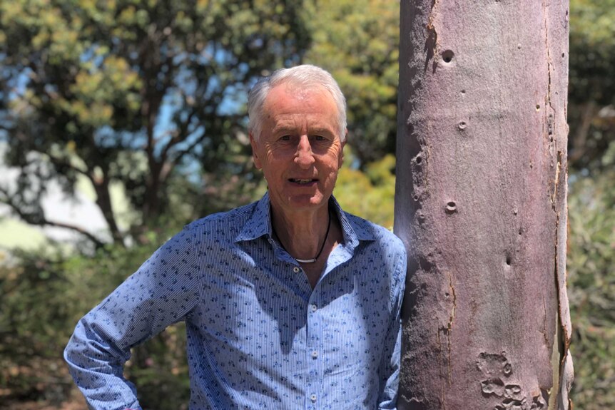 Professor Ross Dowling standing next to a tree at Edith Cowan University.