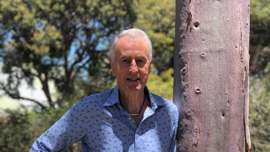 Professor Ross Dowling standing next to a tree at Edith Cowan University.