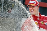 Michael Schumacher sprays champagne from the podium after the 2004 Belgium Grand Prix.