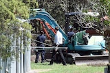 Police excavate a section behind the foster home of Queensland schoolgirl Tiahleigh Palmer