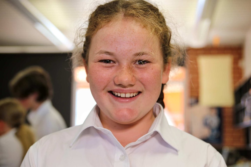 A head and shoulders shot of a smiling female Year 7 student.