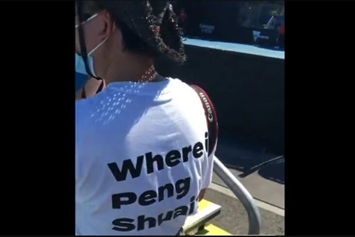 A woman's back wearing a white t-shirt with Where is Peng Shuai written on it