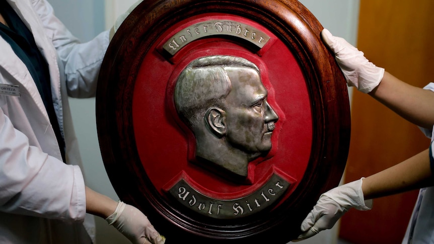 Members of the federal police show a bust relief portrait of Nazi leader Adolf Hitler in Argentina.