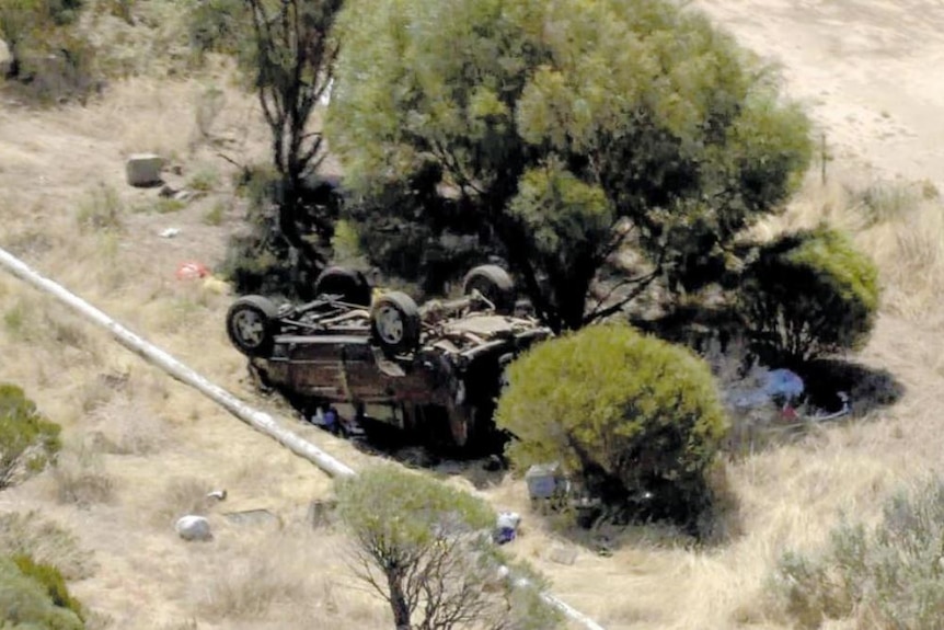 A 4WD flipped on its back off a rural road