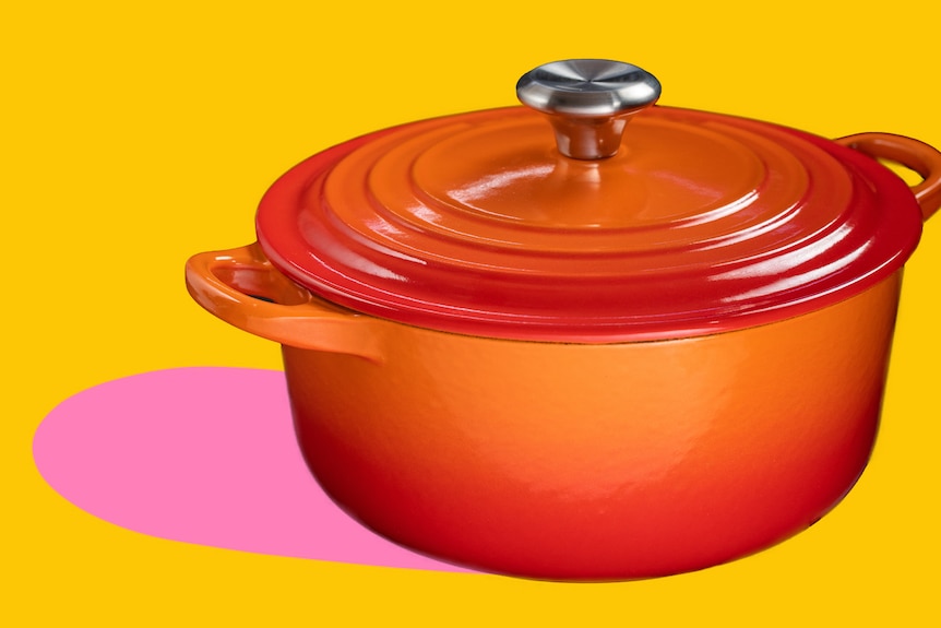 A burnt orange cast iron pot is seen cut out against a yellow background with a pink shadow on the left.