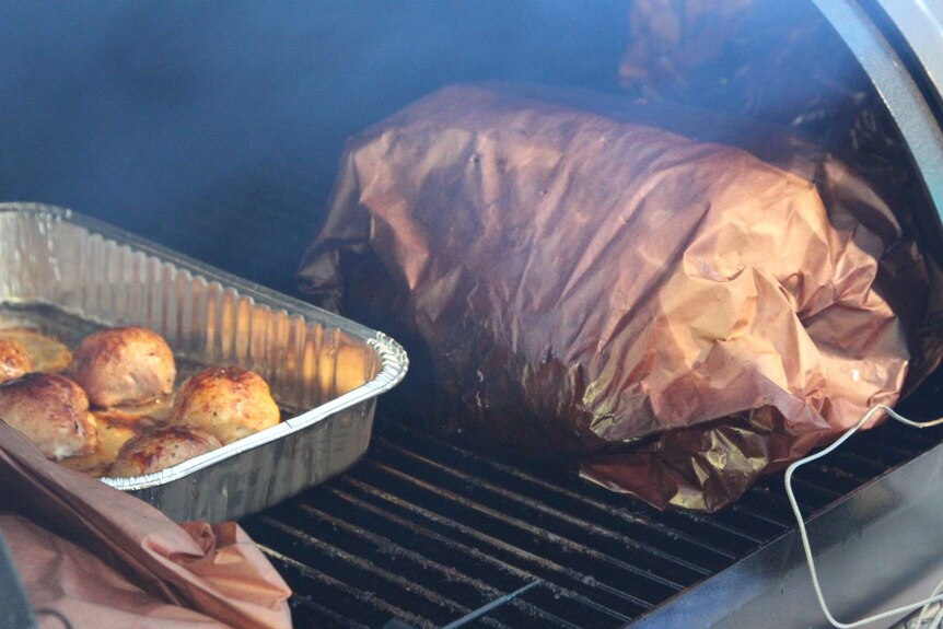 Wrapped bundles of meat on BBQ