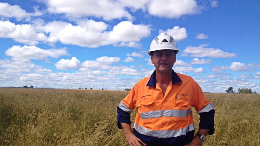 The manager of the mine's cattle company stands in improved pastures where there was once a mine.