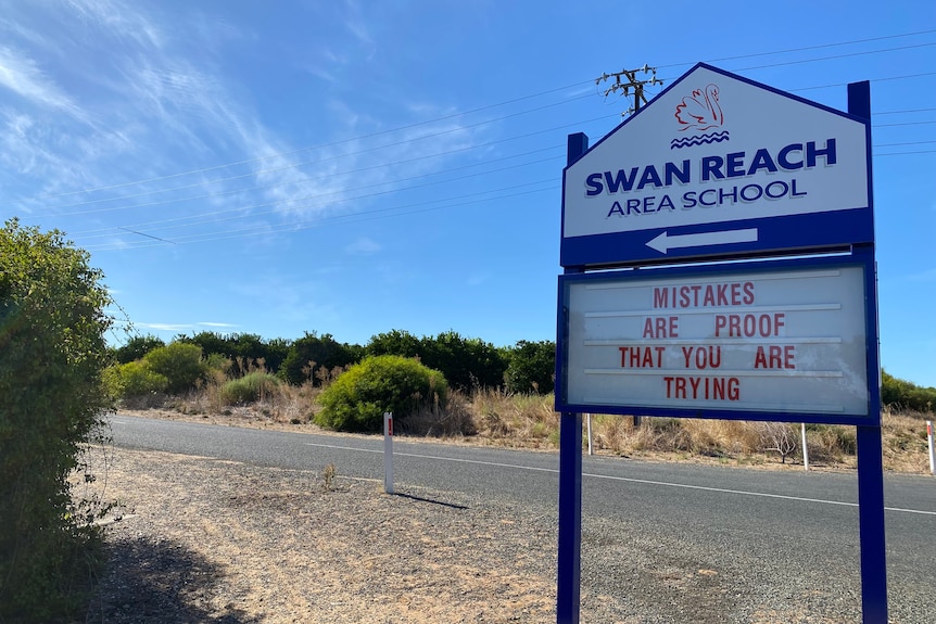 A school sign reads: Swan Reach Area School. Mistakes are proof that you are trying. The sign is red and navy blue