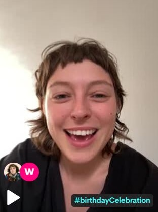 Stella Donnelly speaks to the camera with the words "birthday celebration" at the bottom of the screen